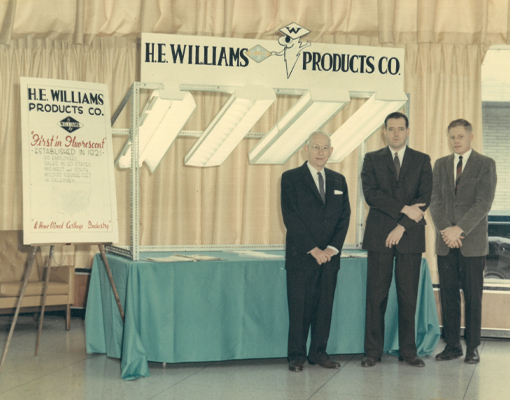H.E. Williams and John Williams showcasing fixtures with the First in Fluorescent slogan
